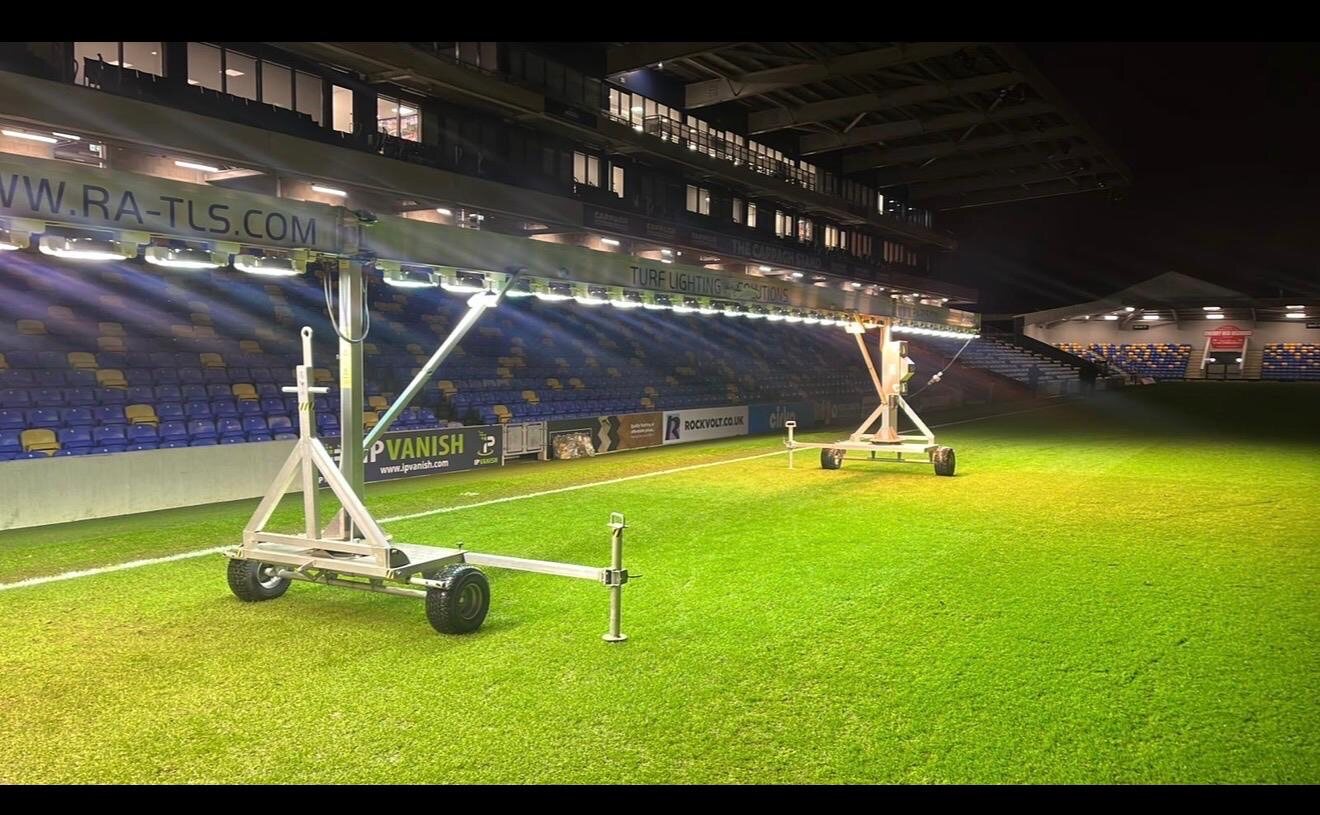 Grow lights on a stadium pitch at night